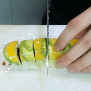 cutting-the-mango-avocado-inside-out-sushi-roll-japanese-food