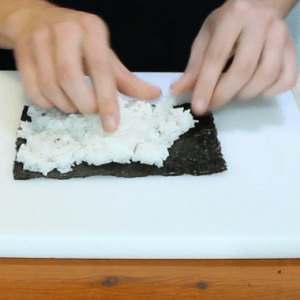 how-to-spread-out-rice-over-a-sheet-of-seaweed-paper-japanese-cusine
