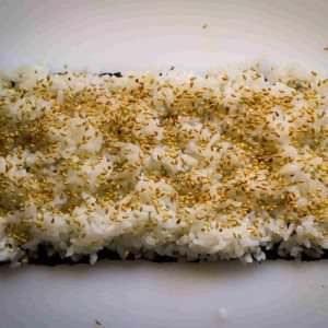 half-a-nori-sheet-with-cooked-rice-and-sesame-seeds